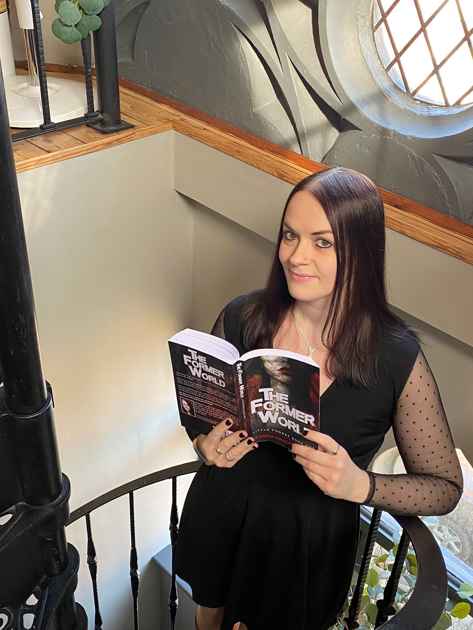 Jessica Grace Coleman pictured with her novel, The Former World